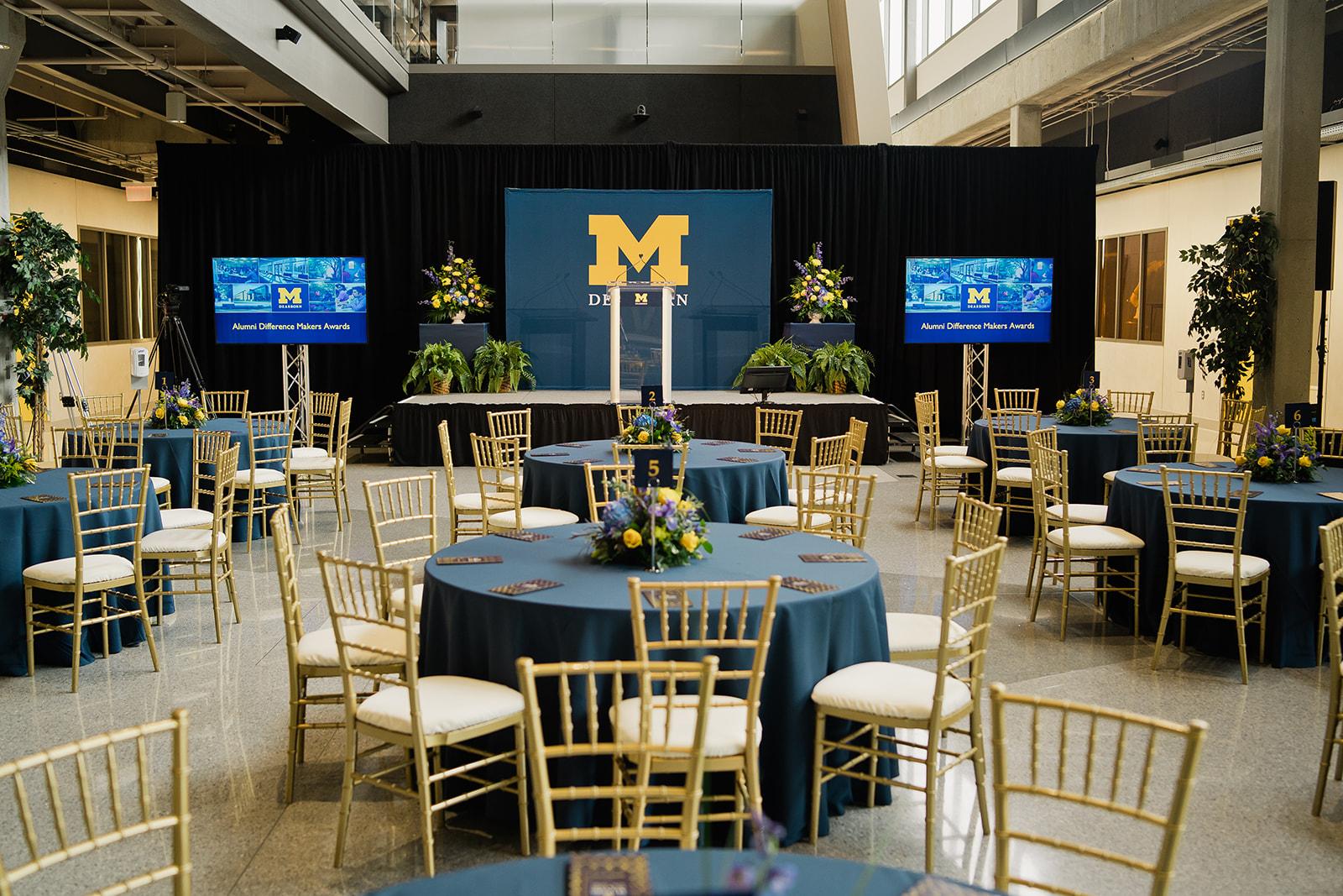 Interior photo of Tony England Engineering Lab Building set for Alumni Awards with stage, podium and tables