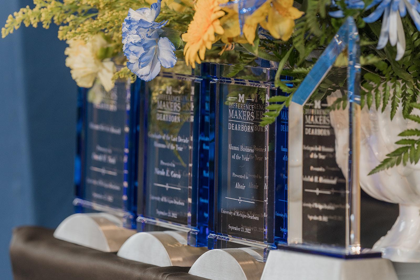 Photo of glass alumni awards with florals