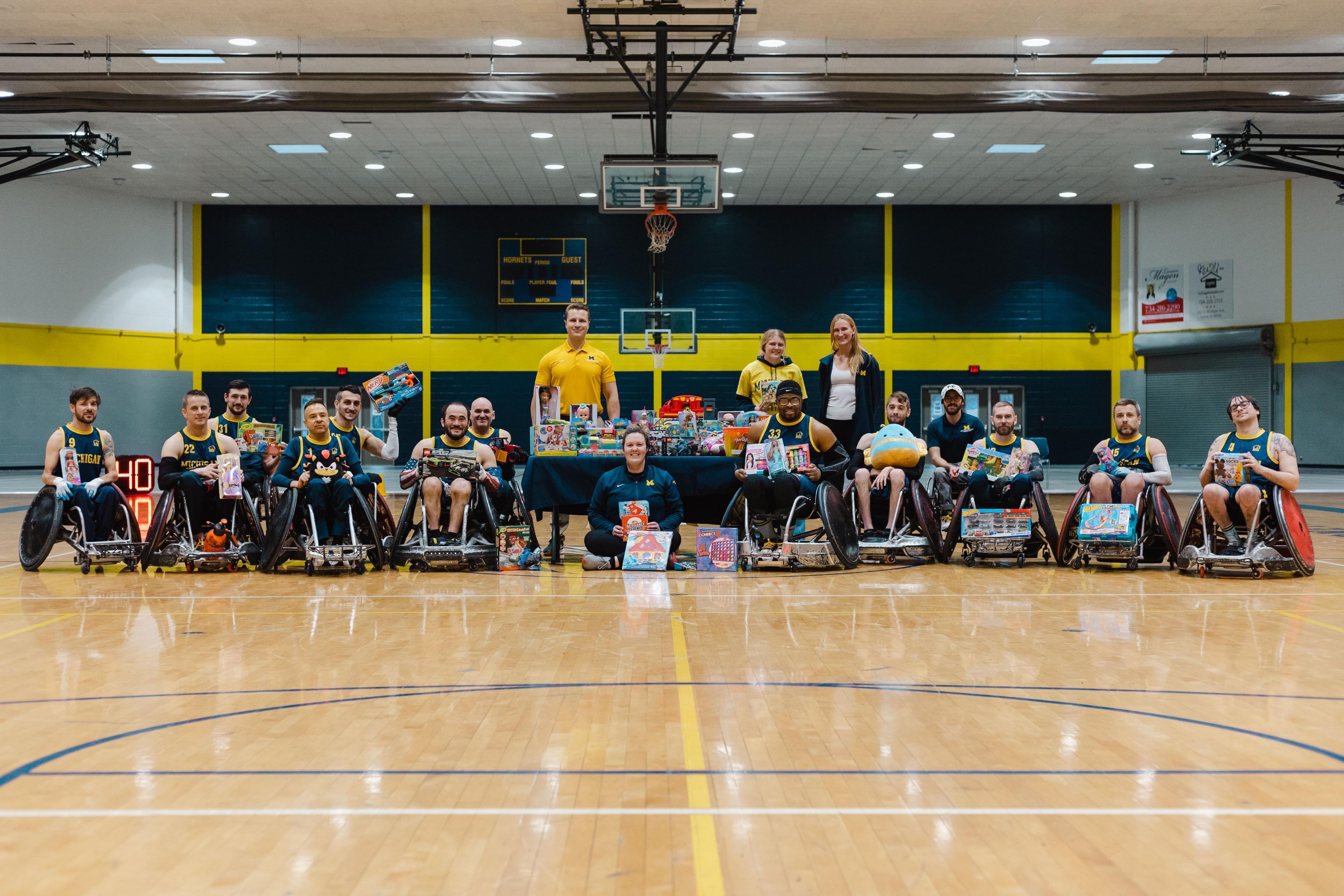 Tournament photo from the coupie classic toy drive, athletes and staff are holding the toys donated